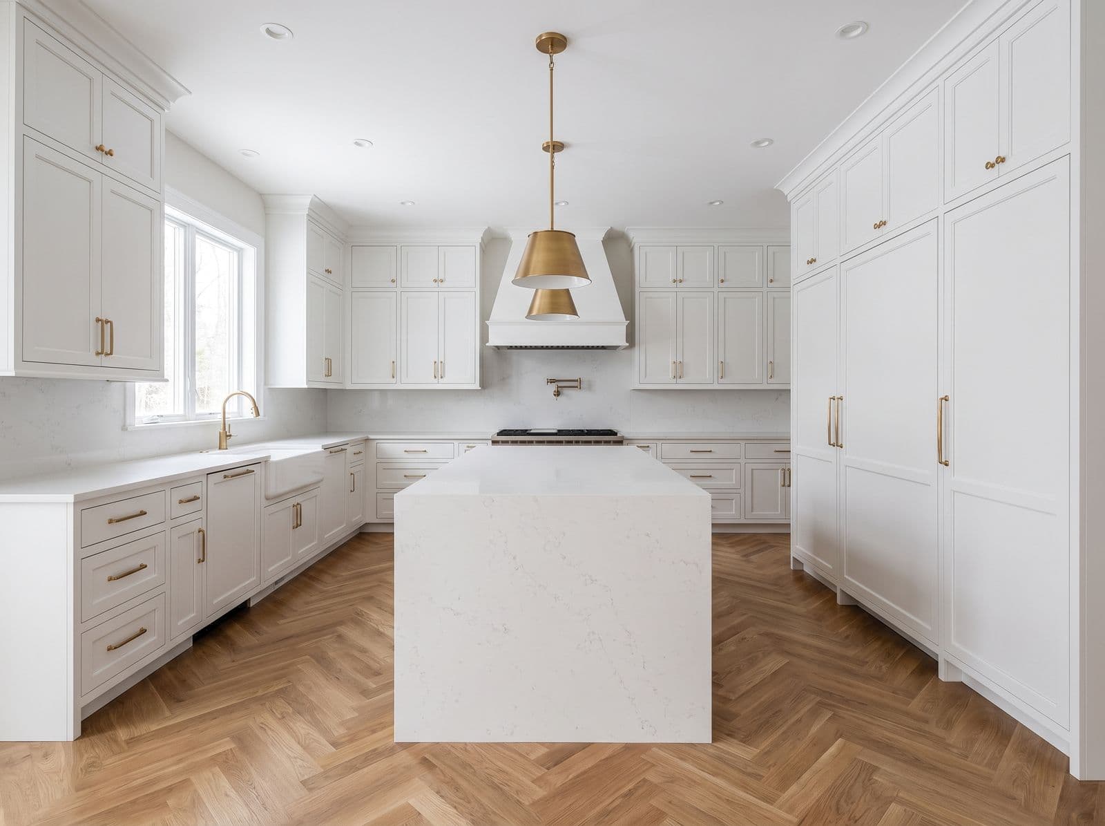 Remodeled kitchen with quartz island and shaker cabinetry